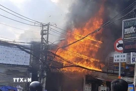 Hiện trường vụ cháy ở phường Phước Long chiều 24/2 (mùng 8 Tết). (Nguồn: TTXVN phát)
