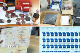 Công cụ, phương tiện của các đối tượng sử dụng để làm giấy tờ giả. (Ảnh: TTXVN phát)