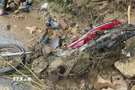 Chiếc xe máy màu đỏ của nạn nhân bị mất tích trên đèo Khánh Sơn đã được tìm thấy, tuy nhiên vẫn chưa tìm thấy người. (Ảnh: Phan Sáu/TTXVN)