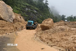 Công ty Cổ phần Quản lý và Xây dựng giao thông Khánh Hòa đang khắc phục sự cố sạt lở đèo. (Ảnh: Xuân Triệu/TTXVN)