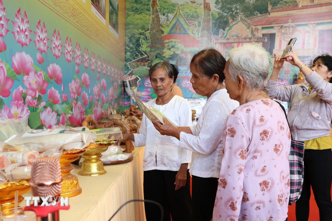 ປະຊາຊົນໄປຢ້ຽມຢາມ ແລະ ຊອກຮູ້ຜະລິດຕະພັນຂອງຊາວເຜົ່າ ຂະແມ ຢູ່ເຂດທັດສະນີຍະພາບແຫ່ງຊາດ ອ່າວອ໋າມ. (ພາບ: ແທງຮວາ/VNA) ttxvn-le-hoi-ok-om-bok-8387963.jpg