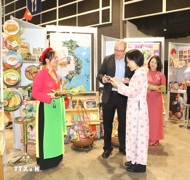 Tổng Lãnh sự Israel tại Hong Kong Amir Lati và Tổng Lãnh sự Việt Nam tại Hong Kong và Macau Lê Đức Hạnh tại gian trưng bày của Việt Nam. (Ảnh: Xuân Vịnh/TTXVN) ttxvn-am-thuc-viet-nam-tai-hoi-cho-sach-hong-kong-trung-quoc-8159399.jpg