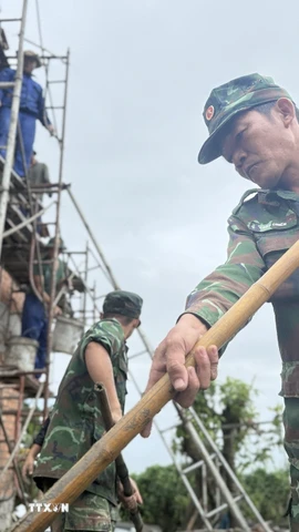 Chiến sĩ Quân khu 5 giúp xây nhà cho người dân tại xã Hòa Thịnh, Đắk Lắk. (Ảnh: Tường Quân/TTXVN)