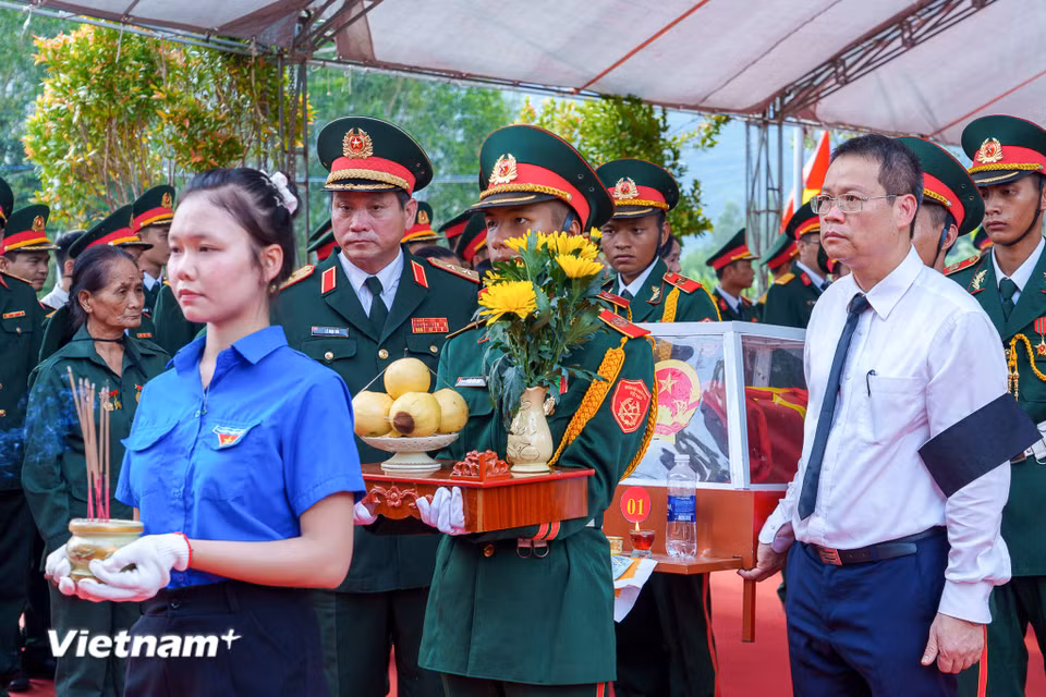 Trung tướng Lê Ngọc Hải, Ủy viên Trung ương Đảng, Tư lệnh Quân khu 5 cùng Phó Bí thư Thành ủy, Chủ tịch Ủy ban nhân dân thành phố Nguyễn Mạnh Hùng cẩn thận đưa hài cốt các liệt sĩ về nơi yên nghỉ. (Ảnh: Thanh Phong/Vietnam+)