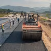 Nhà thầu thi công thảm nhựa nền đường một dự án đường bộ cao tốc. (Ảnh: Việt Hùng/Vietnam+)
