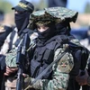 Các thành viên lữ đoàn Al-Qassam, cánh vũ trang của phong trào Hồi giáo Hamas. (Ảnh: IRNA/TTXVN)