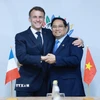 Thủ tướng Phạm Minh Chính gặp Tổng thống Pháp Emmanuel Macron. (Ảnh: Dương Giang/TTXVN)