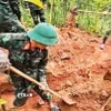 Các hài cốt được tìm thấy tại khu vực rừng tràm của một hộ dân ở thôn Trại Cá, xã Đakrông, tỉnh Quảng Trị. (Ảnh: TTXVN phát)