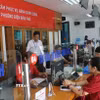 Cán bộ tiếp nhận hồ sơ giải quyết thủ tục cho người dân tại Trung tâm Phục vụ hành chính công phường Điện Biên Phủ (tỉnh Điện Biên) trong ngày đầu vận hành thử nghiệm. (Ảnh: Phan Quân/ TTXVN)