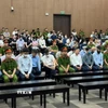 Các bị cáo nghe Tòa tuyên án. (Ảnh: Quốc Lũy/TTXVN)