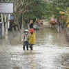 Buôn Nu, xã Uar (tỉnh Gia Lai) vẫn ngập sâu trong nước sau bão số 13. (Ảnh: Hoài Nam/TTXVN)