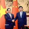 Thủ tướng Phạm Minh Chính hội kiến Chủ tịch Chính hiệp toàn quốc Trung Quốc Vương Hộ Ninh. (Ảnh: Dương Giang/TTXVN)