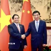 Thủ tướng Phạm Minh Chính hội kiến Chủ tịch Chính hiệp toàn quốc Trung Quốc Vương Hộ Ninh. (Ảnh: Dương Giang/TTXVN)