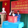Già làng, người có uy tín Hồ Văn Xi và em Hồ Thị Thiều (cử tri lần đầu tiên đi bỏ phiếu) bỏ phiếu bầu đại biểu Quốc hội khóa XVI và đại biểu Hội đồng nhân dân các cấp nhiệm kỳ 2026-2031. (Ảnh: Tá Chuyên/TTXVN)