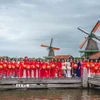 Tự hào những tà áo dài Việt Nam uyển chuyển giữa khung cảnh làng Cối xây gió - biểu tượng của đất nước Hà Lan. (Ảnh: TTXVN)