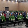 Các bị cáo nghe tòa tuyên án. (Ảnh: Phạm Kiên/TTXVN)