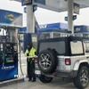 Nhân viên phục vụ khách hàng tại một trạm xăng ở bang New Jersey, Mỹ. (Ảnh: Đoàn Hùng/TTXVN)