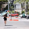 Người dân sử dụng ô khi di chuyển trên phố dưới trời nắng. (Ảnh: Lê Đông/TTXVN)