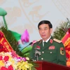 Đại tướng Phan Văn Giang, Ủy viên Bộ Chính trị, Phó Bí thư Quân ủy Trung ương, Bộ trưởng Bộ Quốc phòng trình bày Báo cáo chính trị. (Ảnh: Trọng Đức/TTXVN)