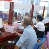 Người dân đến làm các thủ tục hành chính trong ngày 1/7 tại Trung tâm phục vụ hành chính công xã Đức Cơ, tỉnh Gia Lai. (Ảnh: Quang Thái/TTXVN)