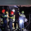 Lực lượng phòng cháy chữa cháy dập tắt đám cháy tại cửa hàng phụ tùng xe máy điện. (Nguồn: Báo Bắc Giang)