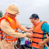 Việc hỗ trợ người dân mặc áo phao được lực lượng chức năng duy trì thường xuyên nhằm nâng cao ý thức bảo đảm an toàn giao thông đường thủy. (Ảnh: Trung Nguyên/TTXVN)