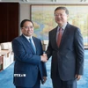 Thủ tướng Phạm Minh Chính gặp Bí thư Thành ủy Thượng Hải Trần Cát Ninh. (Ảnh: Dương Giang/TTXVN)