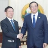 Phó Thủ tướng Hồ Đức Phớc hội kiến Thủ tướng Lào Sonexay Siphandone. (Ảnh: Đỗ Bá Thành/TTXVN)