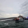 Lực lượng chức năng tiếp cận tàu đắm trên vịnh Hạ Long, tiến hành cứu hộ, cứu nạn. (Ảnh: Thanh Vân/TTXVN)