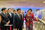 Tổng Giám đốc Thông tấn xã Việt Nam giới thiệu những hình ảnh quý trong triển lãm. (Ảnh: Mai Mai/Vietnam+)