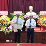 Phó Chủ tịch Ủy ban Nhân dân thành phố Cần Thơ Trần Chí Hùng trao Bằng khen của Chủ tịch Ủy ban Nhân dân thành phố cho Anh hùng lao động, kỹ sư Hồ Quang Cua. (Ảnh: Thanh Liêm/TTXVN)