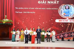 Ông Tống Thanh Hải, Phó Chủ tịch Thường trực UBND tỉnh và ông Lê Đức Dục, Trưởng Ban Tuyên giáo Tỉnh ủy, Trưởng Ban Tổ chức Cuộc thi, trao giải Nhất cho tác giả Đặng Thị Thúy (thành phố Hải Phòng) ở thể loại truyện ngắn. (Nguồn: Vietnam+)