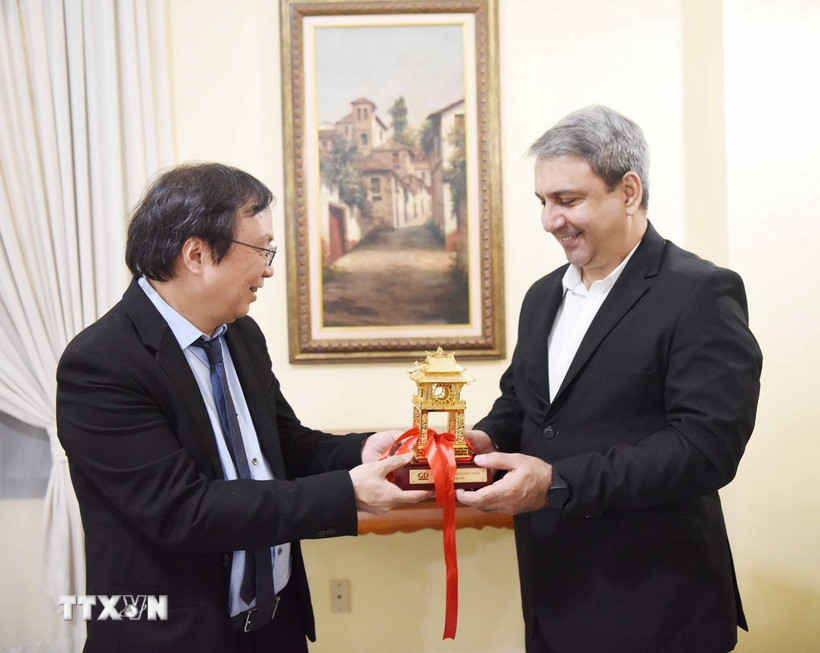 Chủ tịch Hội đồng thành viên, Tổng Giám đốc NXB Giáo dục Việt Nam Nguyễn Tiến Thanh (trái) trao quà lưu niệm cho Bộ trưởng Bộ Đại học Cuba Walter Baluja García. (Ảnh: Việt Hùng/TTXVN)