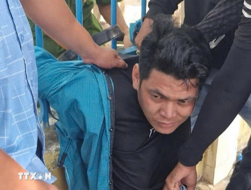 Nghi phạm Đinh Thanh Tùng bị công an bắt giữ. (Ảnh: TTXVN phát)