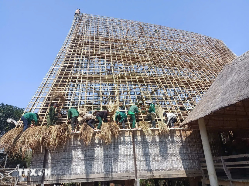 Người dân lợp lại mái nhà rông. (Ảnh: Hồng Điệp/TTXVN)