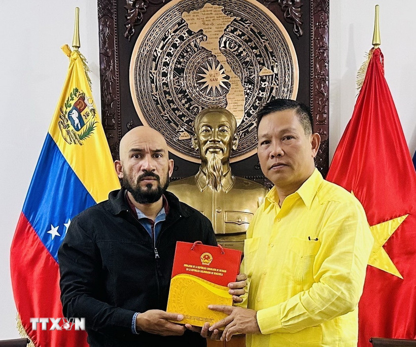 Đại sứ Việt Nam tại Venezuela tặng quà lưu niệm cho Giáo sư José Javier Díaz Macadan. (Ảnh: TTXVN phát)