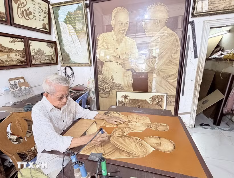 Nghệ nhân Võ Văn Tạng tái hiện chân dung Chủ tịch Hồ Chí Minh và Chủ tịch Tôn Đức Thắng trên chất liệu lá thốt nốt đặc trưng vùng Bảy Núi An Giang. (Ảnh: Thanh Sang/TTXVN)