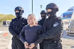 Lý Hùng bị dẫn độ về nước. (Ảnh: China Daily)