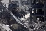 Những tòa nhà tại thành phố Gaza bị phá hủy sau đòn pháo kích của Israel ngày 24/3. (Ảnh: THX/TTXVN)