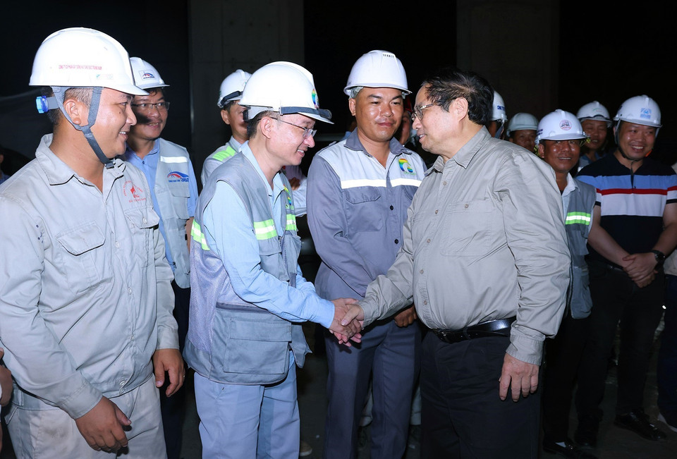 Thủ tướng Phạm Minh Chính với công nhân thi công cầu Rạch Miễu 2, thành phố Mỹ Tho, tỉnh Tiền Giang. (Ảnh: Dương Giang/TTXVN)
