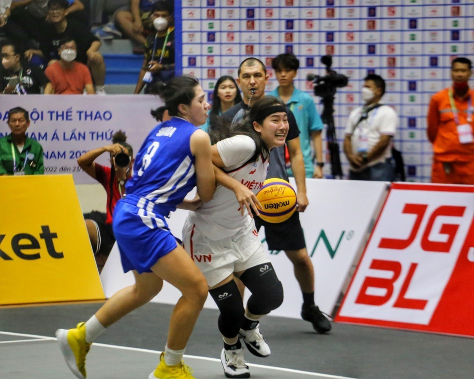 Kayleigh Trương (số 11, Việt Nam, áo trắng) dẫn bóng trong sự kìm kẹp của Angelica Surada (số 8, Philippines, áo xanh). (Ảnh: Tuấn Đức/TTXVN)