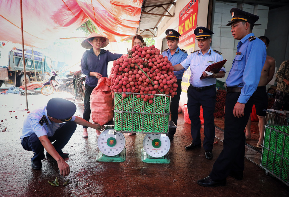 Đội Quản lý thị trường số 5 liên tục đi kiểm tra hoạt động cân vải, chống gian lận làm thiệt hại cho người dân. (Ảnh: Danh Lam/TTXVN)
