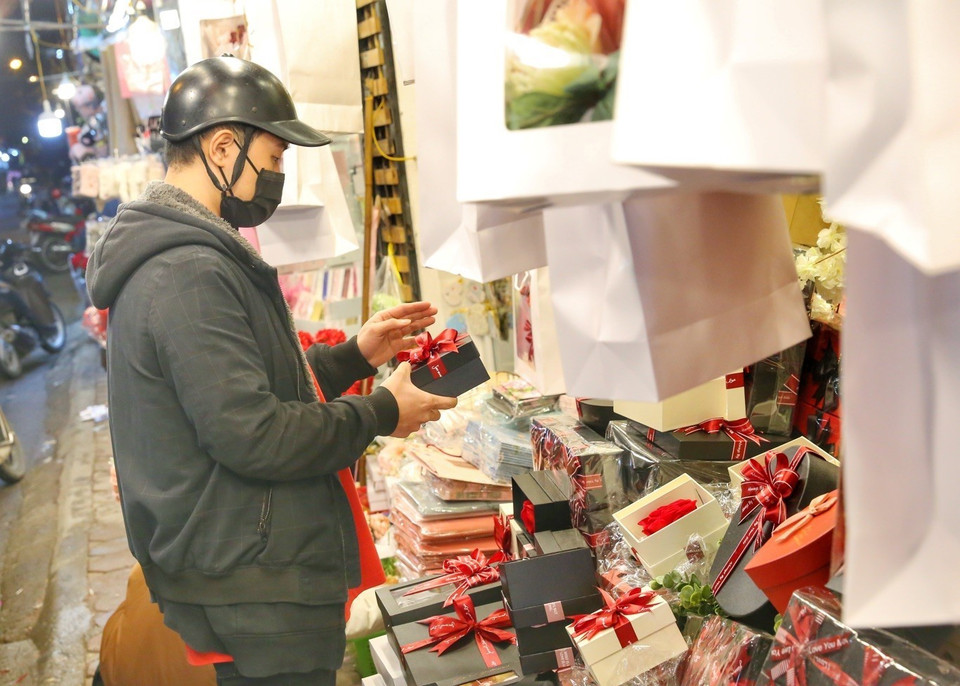 Các bạn trẻ đi mua những món quà cho "nửa kia" của mình. (Ảnh: Tuấn Đức/TTXVN)