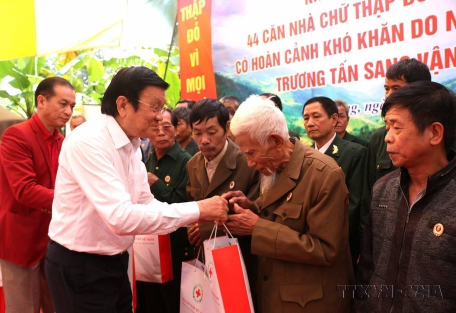 Nguyên Chủ tịch nước Trương Tấn Sang tặng quà cho các cựu chiến binh có hoàn cảnh khó khăn đã từng tham gia chiến đấu trên tuyến biên giới phía Bắc từ năm 1979-1989. (Ảnh: TXVN phát)