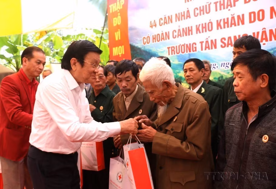 Nguyên Chủ tịch nước Trương Tấn Sang tặng quà cho các cựu chiến binh có hoàn cảnh khó khăn đã từng tham gia chiến đấu trên tuyến biên giới phía Bắc từ năm 1979-1989. (Ảnh: TXVN phát)