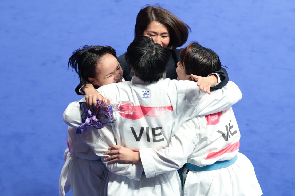 HLV Nguyễn Hoàng Ngân (áo đen) và 3 thành viên đội tuyển Karate kumite đồng đội Nữ. (Ảnh: Hoàng Linh/TTXVN)
