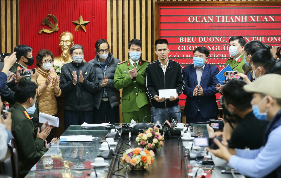 Lãnh đạo quận Thanh Xuân tặng quà cho tài xế xe tải Nguyễn Ngọc Mạnh. (Ảnh: Doãn Tấn/TXVN)