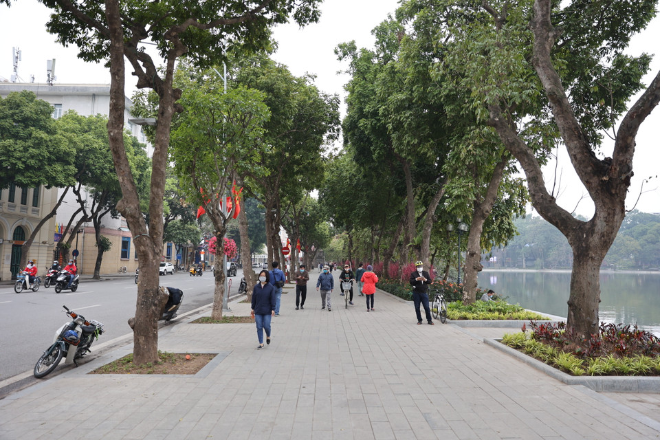 Nhiều người dân Thủ đô đã dậy sớm để đi dạo quanh khu vực Hồ Hoàn Kiếm để tận hưởng không khí ngày đầu năm. (Ảnh: Minh Hiếu/Vietnam+)