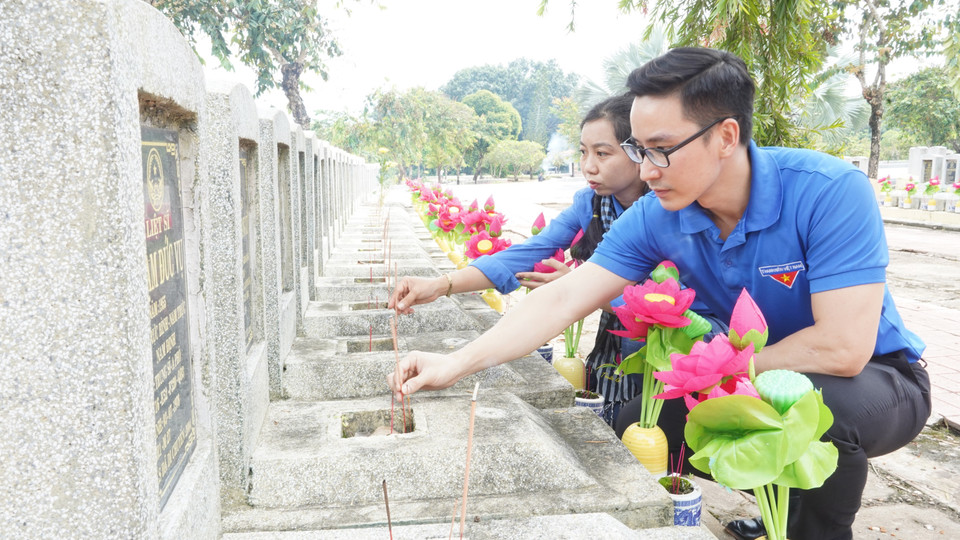 Đoàn Thanh niên Cơ quan Thông tấn xã Việt Nam khu vực phía Nam dâng hương tại mộ liệt sỹ thuộc Nghĩa trang Liệt sỹ Đồi 82 (huyện Tân Biên, tỉnh Tây Ninh). (Ảnh: Thanh Tân/TTXVN)