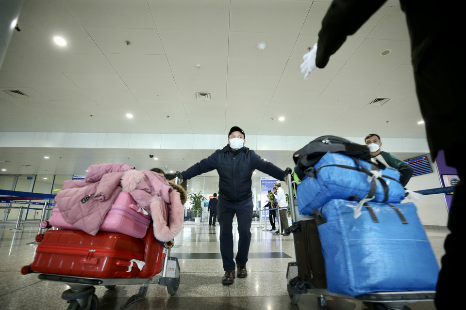 Anh Trần Bá Vượng trở về Hà Nội với nhiều valy và đồ dùng, sau hơn 20 năm định cư ở Ukraine. Cả gia đình anh hơn 17 người về nước trong đợt này. (Ảnh: Lâm Khánh/TTXVN)